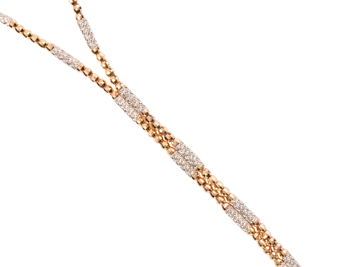 Close-up of the lariat drop of the Magnetic Beaded Two-Tone Convertible in 18k yellow and white gold